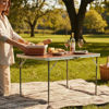 Imagen de Mesa de aluminio plegable, tapa símil madera color oscuro, con asa, en caja